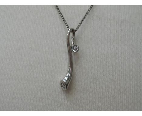A Georg Jensen magic white gold pendant set with two brilliant cut diamonds  on an 18ct white gold chain, in original case