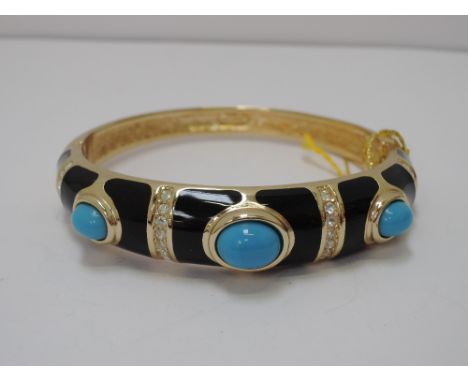 A 1980's hinged bangle by Grosse having black enamel panel with turquoise stones and bands of diamante