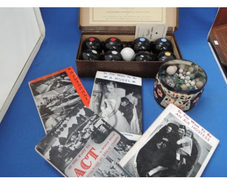 A vintage set of Banda carpet bowls, four volumes including 'So you want to be a Model' and a selection of vintage marbles