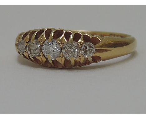 A ladies dress ring having five graduated diamonds in a raised mount on an 18ct gold loop