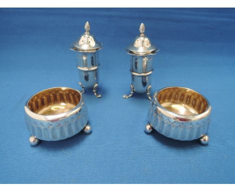 A pair of Victorian silver salts of circular fluted form on trefoil bun feet, London 1883, Edward Hutton, and a pair of silve