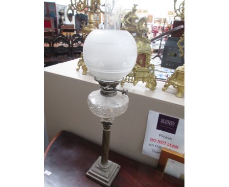 A late Victorian oil lamp having cut glass reservoir, on brass plated corinthian  column with replacement shade