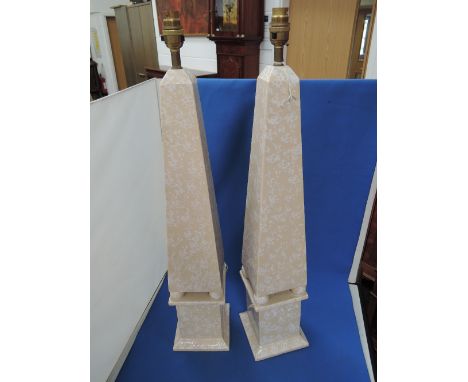 A pair of late 20th century ceramic table lamps modelled as buff obelisks, retailed by Harrods