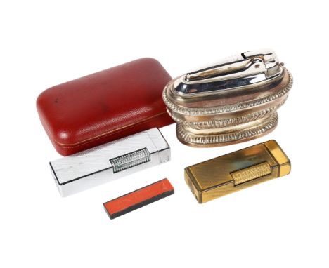 A Vintage Dunhill gold plated lighter in original case, a Ronson silver plated table lighter, and a Colibri chrome plate ligh