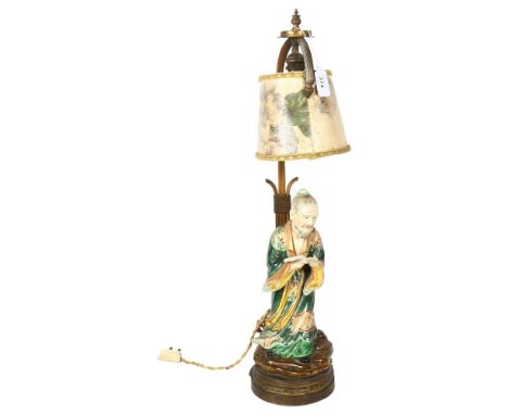 A Japanese 19th century porcelain figure of a man holding a book, mounted on a gilt-metal lamp stand, overall height 60cm 