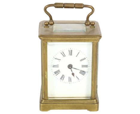 A French brass-cased carriage clock, white enamel dial with Roman numerals and bevelled glass exhibition plates, case height 