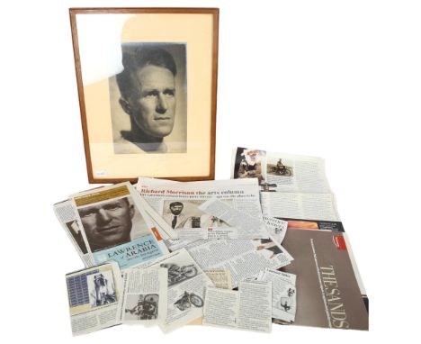 A framed photographic portrait of T E Lawrence, together with a quantity of newspaper cuttings relating to his life and vario