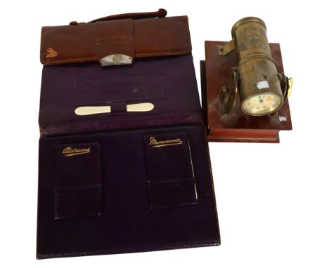 A 20th century projection clock, together with an early 20th century leather folding travelling organiser 