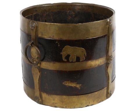 A 19th century Indian wood and brass-bound bucket with ring handles, stylised strapwork and animal decoration, diameter 26cm,