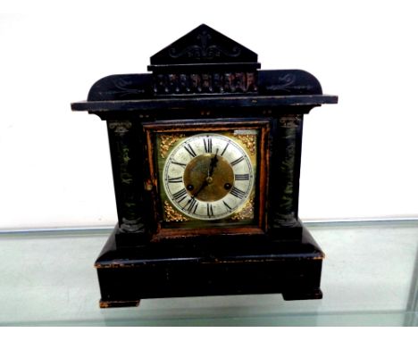 A late Victorian stained wooden mantel clock with brass and silver dial  