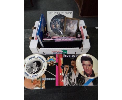 A box of Elvis Presley memorabilia to include records, books, framed pictures, collector's plates, Elvis pink Cadillac die ca