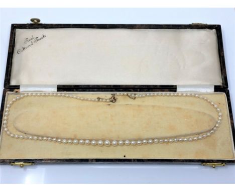 A single strand cultured pearl necklace with yellow metal clasp