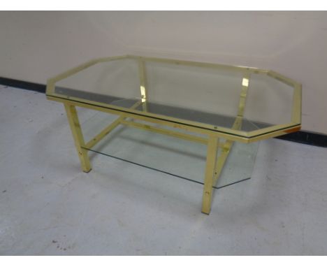 An octagonal brass glass topped coffee table with under shelf 