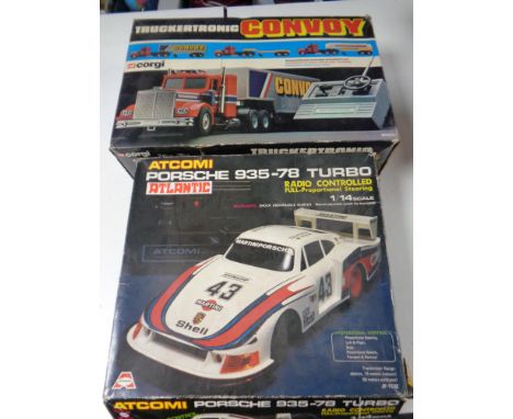 A boxed vintage Corgi Truckertronic Convoy M5600 remote controlled truck together with a further boxed Atcomi Porsche Turbo r