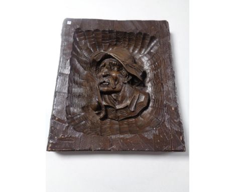 A wall plaque depicting a gentleman smoking a pipe 