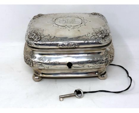 A 19th century German silver tea caddy, coat of arms to lid, on ball feet, original silver key.  CONDITION REPORT: 276g