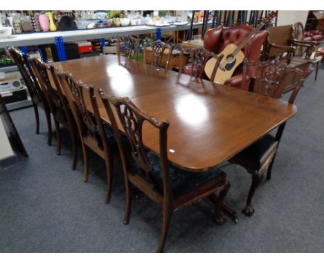 A twin pedestal mahogany dining table with two extension leaves, total length 304 cm, together with a set of six reproduction