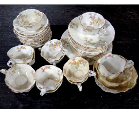 An antique floral patterned bone china tea service