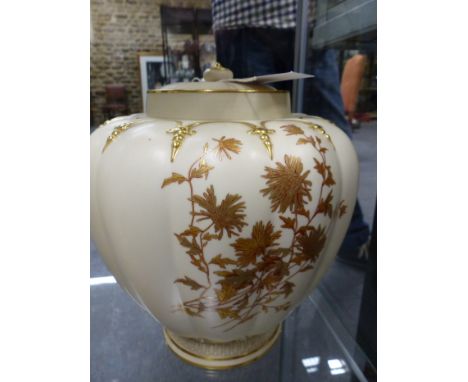 A Royal Worcester Eastern inspired lobed form covered vase with raised gilt moulded decoration with floral sprays. 25.5cm hig