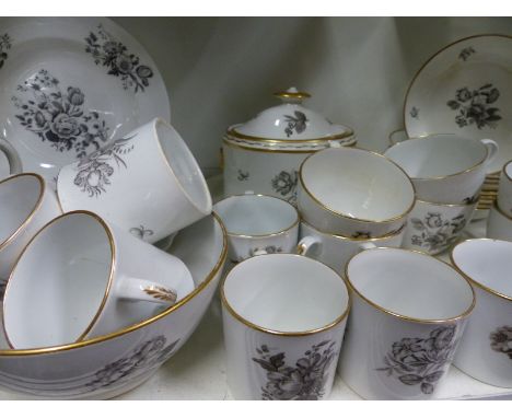 An antique English floral decorated part tea service to include various cups, saucers, cream jug, etc.