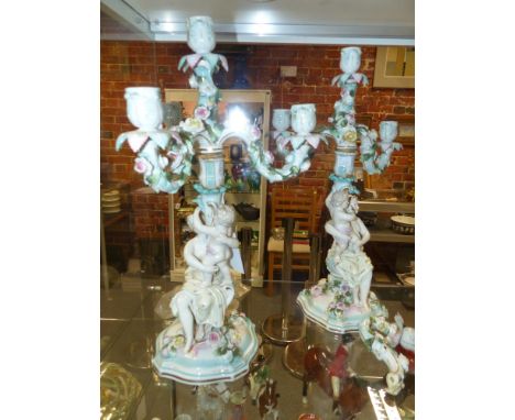 A pair of German Meissen style four light figural candelabra applied raised polychrome floral decoration. 46cm high