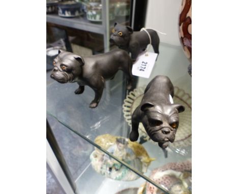Three Wedgwood black Basalt figures of Bull dogs with inset glass eyes. Largest 12.5cm long
One of the figures is unmarked an