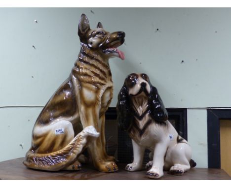 Two large decorative pottery figures of dogs, a spaniel and a German shepherd, height of largest. 70cm