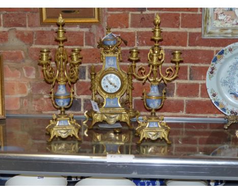 An ormolu mounted three piece French blue Jasper ware clock garniture in the Louis XVI style, a pair of five light candelabra