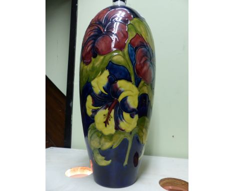 A large Moorcroft pottery lamp base with floral decoration. 38cm high