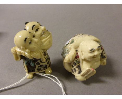 Two Netsuke including Man carrying head in sack and a Happy Buddha