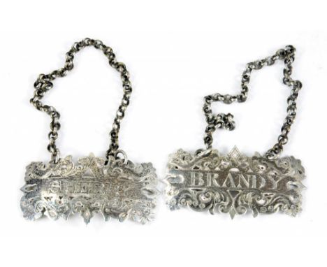 A PAIR OF VICTORIAN PIERCED AND ENGRAVED SILVER DECANTER LABELS - BRANDY AND SHERRY, 5CM W, CHAINED, LONDON 1845, 18DWTS