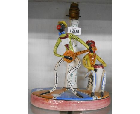 A 1950's Italian tin glazed ceramic lamp depicting minstrels playing instruments - a/f
