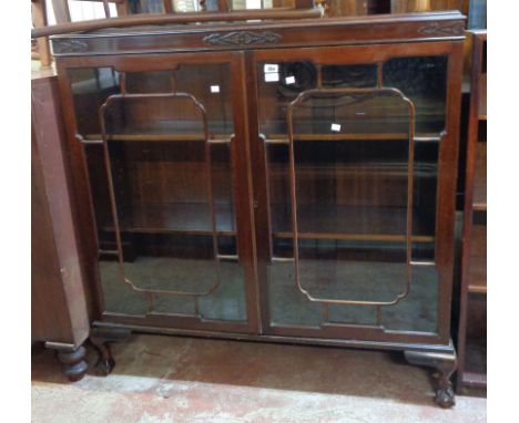 A 1.2m 1920's mahogany book cabinet in the antique style with adjustable shelves enclosed by a pair of beaded glazed panel do