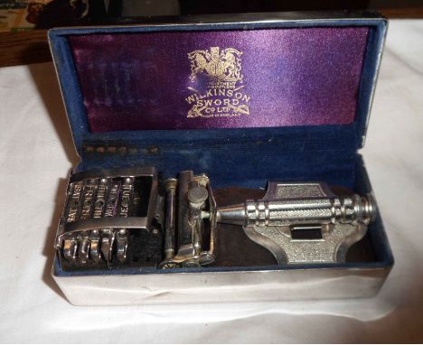 A vintage Wilkinson Sword in original fitted metal tin wiith five spare blades