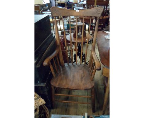 An old high stick back elbow chair with moulded solid elm seat, set on ring turned supports - oiled finish