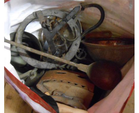 A bag containing a large quantity of metalware including Eastern copper pans, wrought iron pot hanger, Eastern beaten copper 
