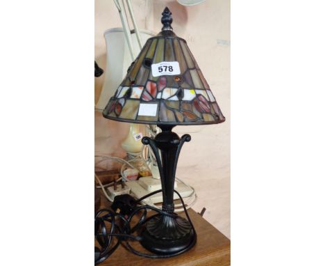 A resin table lamp with Tiffany style glass shade