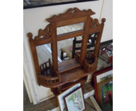 A modern far eastern hard wood hall mirror in the Victorian style with multiple plates, flanking spindle gallery shelves and 