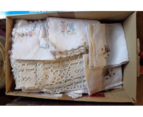 A box containing a quantity of assorted linen and other textiles including tablecloth, tray cloths, etc.