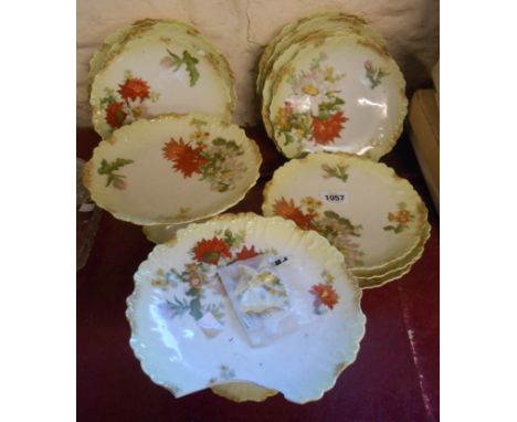 A Limoges porcelain dessert service comprising two comports and twelve plates, each decorated with a bold floral transfer pri