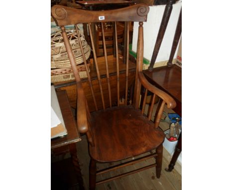 An old high stick back elbow chair with moulded solid elm seat, set on ring turned supports - oiled finish