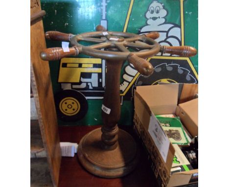 A 45cm diameter vintage brass ship's six spoke wheel, mounted on a stained wood pedestal with turned pillar and circular base