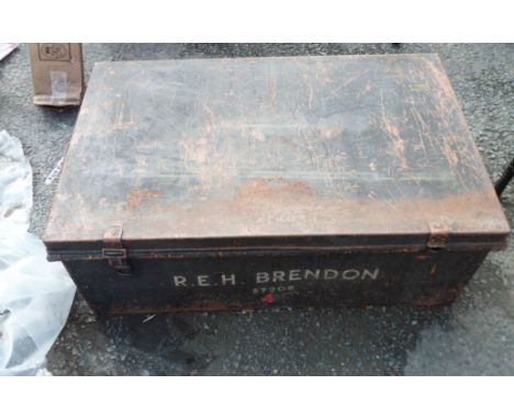 An old metal trunk with black jappaned finish with R.E.H. Brendon 57208 stencilled in white to the front