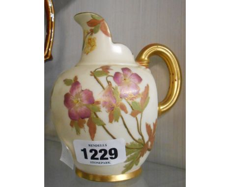 A small Royal Worcester porcelain jug of helmet form decorated with hand painted floral sprays with gilt highlighting on an i