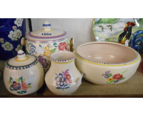 A small selection of Poole Pottery items comprising biscuit barrel, bowl, preserve pot and vase