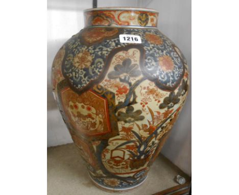 A large antique Chinese porcelain jar with blue and white and iron red painted decoration with panels depicting mythical beas