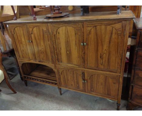 A 1.55m reproduction Edwardian style mixed wood sideboard with four arcaded panel doors over recess and two further cupboard 