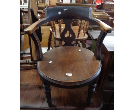 An antique stained wood smoker's bow elbow chair with moulded top rail and pierced splat back, set on turned front legs - rep