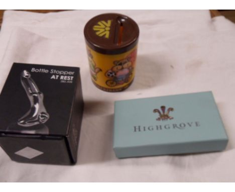 A vintage Commerzbank child's advertising money box - sold with a boxed novelty bottle stopper and a Hydro House boxed silver