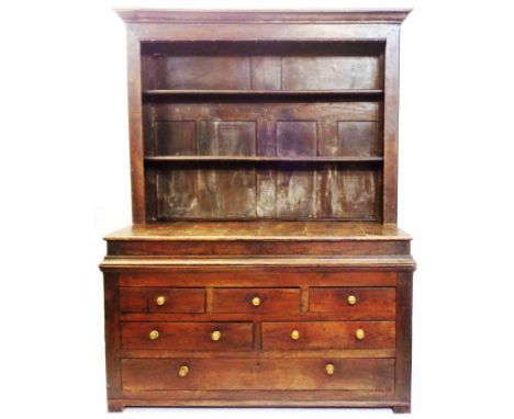 A 1.38m 18th Century oak two part dresser with two shelf open plate rack, heavy fielded panels and staged top to base with an